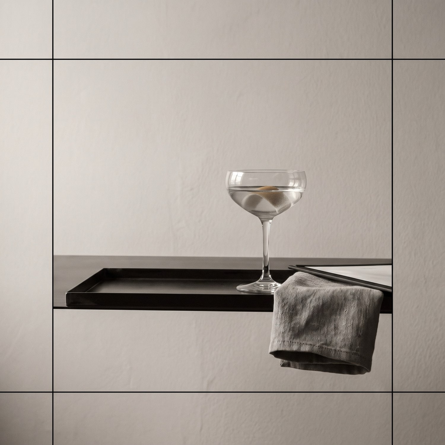 An editorial detail of linen and blackened steel in a suite