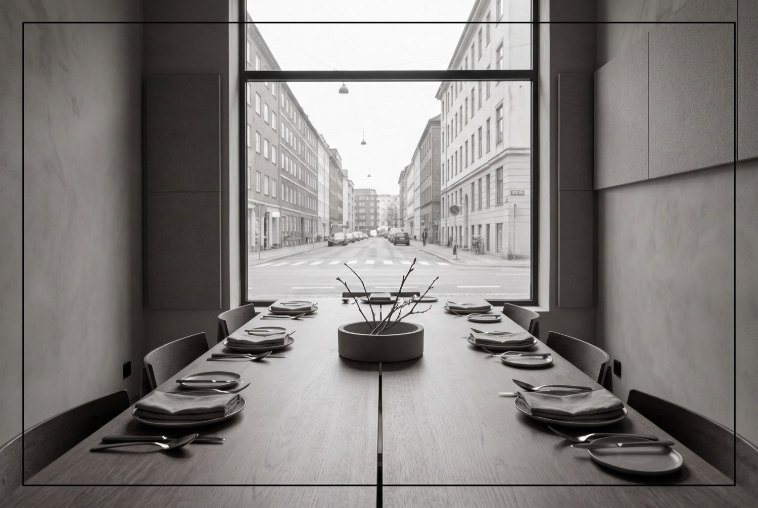 A modern hotel restaurant with a long editorial table set for service